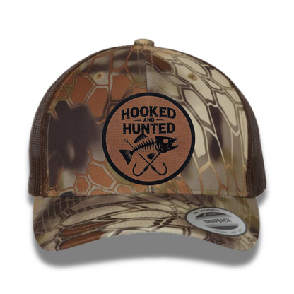 Hooked and Hunted Pebble Leatherette Patch Kryptex Camo 6 Panel Mesh Trucker Hat