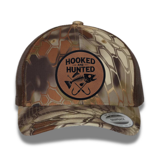 Hooked and Hunted Pebble Leatherette Patch Kryptex Camo 6 Panel Mesh Trucker Hat
